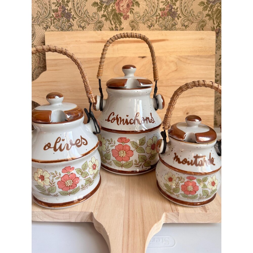 Vintage French condiments labeled pots with lids and rattan handles.